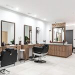 Elegant salon reception area with gold accents and French-style chairs